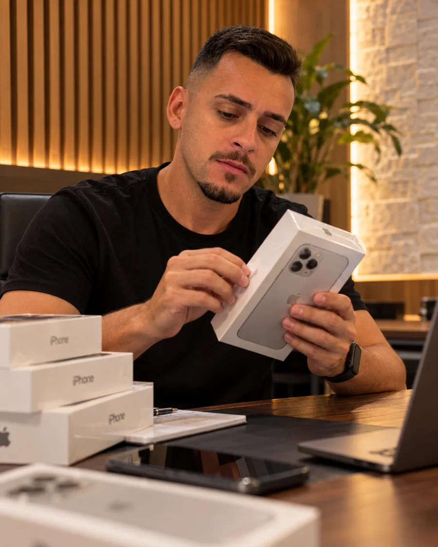 Orlando conferindo caixas lacradas de iPhone na bancada